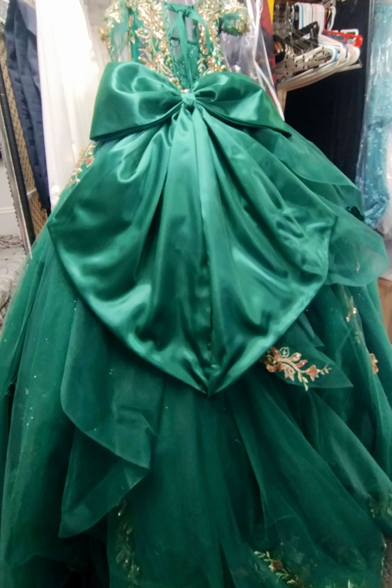 Emerald green ball gown with an oversized satin bow