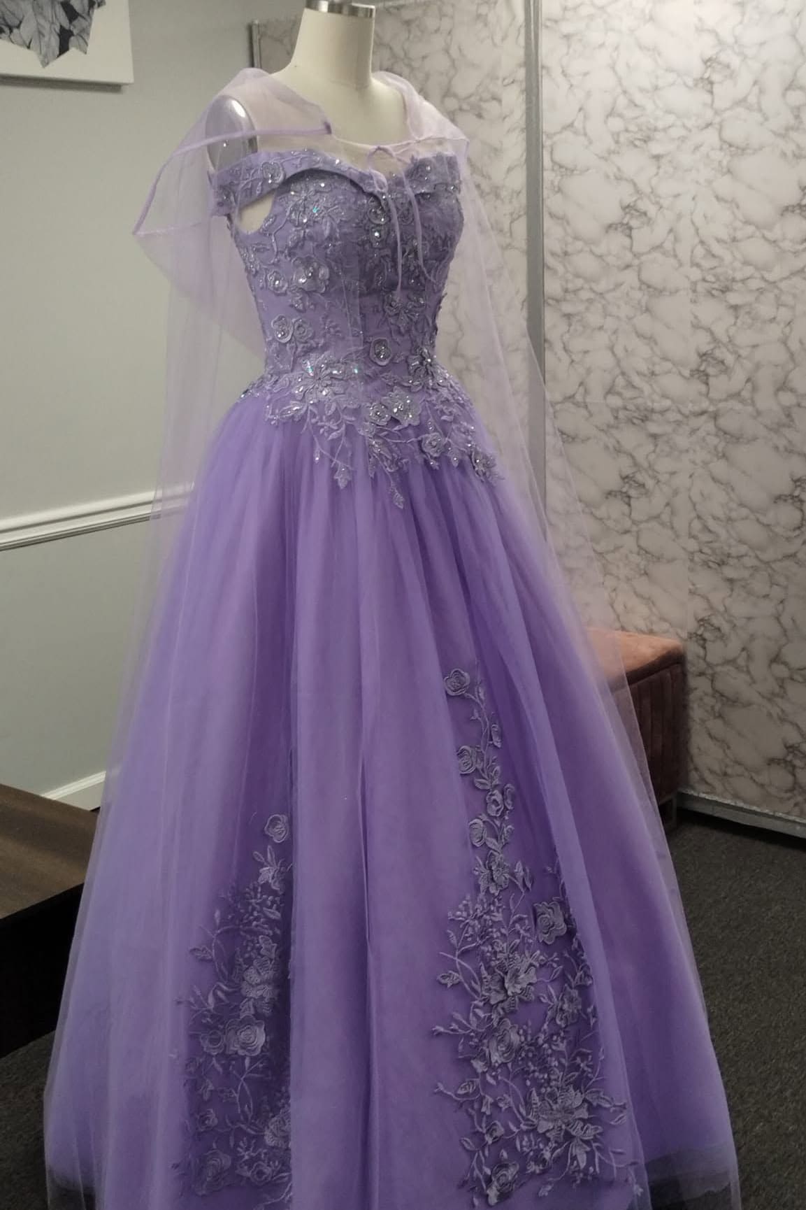 Lavender tulle gown with a beaded bodice and a sheer cape